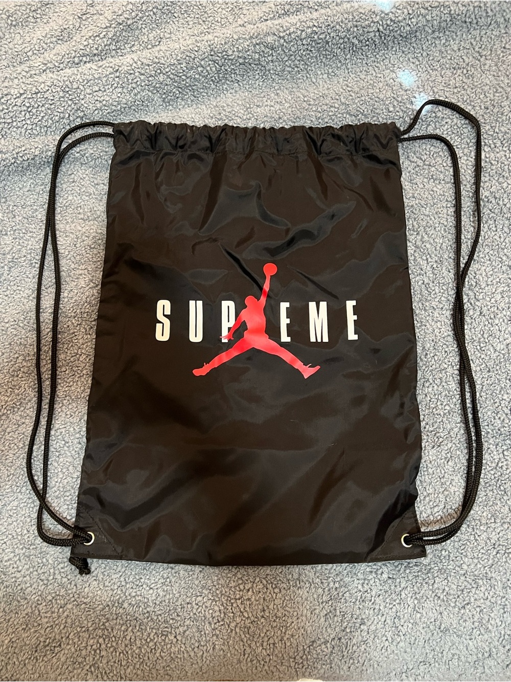 Supreme Black Drawstring Backpack with Red Jumpman Logo